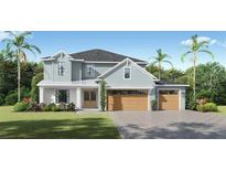 Charming two-story home with a three-car garage, beautiful landscaping, and a well-maintained lawn at 3904 W Vasconia St, Tampa, FL 33629