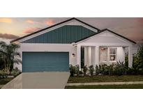 Inviting single Gathering home with a charming entry, blue garage door, and manicured lawn at 10267 Fieldstone Myrtle Way, San Antonio, FL 33576