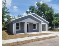 Charming single-story home with a freshly painted exterior, new windows and a well-manicured front yard at 3312 Lila St, Tampa, FL 33610