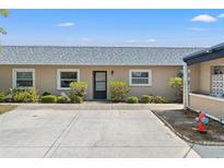 Single story home featuring neutral paint, gray roof, landscaped yard and concrete parking area at 3728 Teeside Dr, New Port Richey, FL 34655