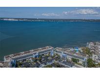 Stunning aerial view of a condo complex overlooking a bay with blue water and skyline in the background at 5277 Isla Key S Blvd # 422, St Petersburg, FL 33715