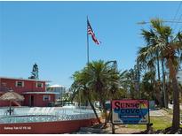 Sunset Cove condominiums offers a delightful exterior with palm trees and beautiful views at 8567 W Gulf Blvd # 17N, Treasure Island, FL 33706