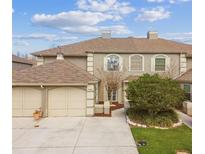 Charming home featuring an attached two-car garage, manicured lawn and mature trees at 14005 Trouville Dr, Tampa, FL 33624