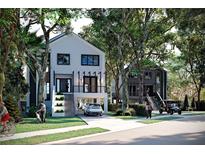 Charming two-story homes with a covered car port, landscaped yard, and a manicured lawn at 1874 Stevenson Ave, Clearwater, FL 33755