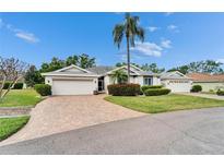 Charming home featuring a well-manicured lawn and a beautiful brick driveway and walkway at 2222 Mayfield Palms Ln # 322, Sun City Center, FL 33573