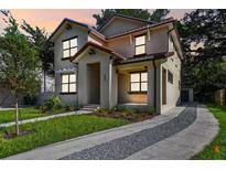 Beautiful two-story home showcasing a well-manicured lawn and a stylish, neutral-toned facade at 2618 15Th N Ave, St Petersburg, FL 33713