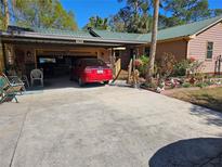 Charming single story home featuring a covered carport and an inviting landscaped front yard at 402 8Th Sw St, Ruskin, FL 33570