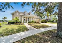 Charming two-story home with manicured lawn, inviting porch, and a two-car garage at 5205 Brighton Shore Dr, Apollo Beach, FL 33572