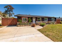 Charming single-story home with a well-maintained lawn, beautiful landscaping, and a welcoming front entrance at 8871 94Th St, Seminole, FL 33777