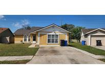 Charming single-Gathering home with well-maintained lawn, neutral color scheme, and a detached one car garage at 2108 Ridgemore Dr, Valrico, FL 33594