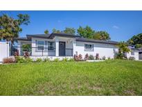 Charming single-story home featuring a freshly landscaped front yard and inviting front porch at 1102 N Albany Ave, Tampa, FL 33607