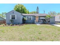 Charming single-story home featuring a well-maintained lawn and a welcoming, light-orange front door at 1528 W River Shore Way, Tampa, FL 33603