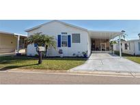 Charming single-story home with a well-maintained lawn and blue trim details at 272 S Port Royal Ln, Apollo Beach, FL 33572