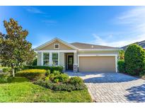 Charming single-story home featuring manicured landscaping, a two-car garage, and a welcoming front porch at 6002 Thrushwood Rd, Lithia, FL 33547