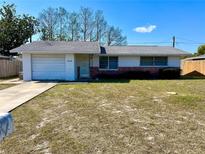 Charming single-story home featuring an attached garage and a well-maintained front yard at 7608 Bougenville Dr, Port Richey, FL 34668