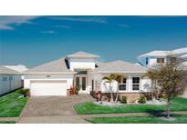 Charming single-story home with a well-manicured lawn, attached garage, and beautiful landscaping at 8261 Ivy Stark Blvd, Wesley Chapel, FL 33545