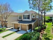 Charming two-story home featuring a two-car garage, manicured landscaping, and a welcoming entryway at 10209 Spanish Breeze Ct, Riverview, FL 33578