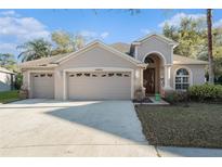 Charming single-story home with a manicured lawn and a two-car garage, perfect for families at 10623 Pearl Berry Loop, Land O Lakes, FL 34638