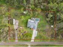 Birds eye view shows the property with an RV, boat and marked property line at 1126 Oxbow Rd, Wimauma, FL 33598