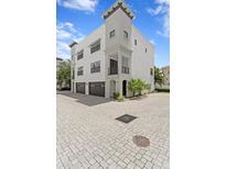 Stunning three-story home with a two-car garage and beautiful architectural details at 224 S Audubon Ave, Tampa, FL 33609