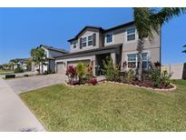 Beautiful two-story home with three-car garage and well-manicured lawn and garden at 4923 Eagle Rock Dr, Wimauma, FL 33598