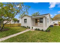 Charming single-story home with a well-manicured lawn and inviting front porch and fresh exterior paint at 4934 Dr Martin Luther King Jr N St, St Petersburg, FL 33703
