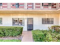 Charming condo entrance with well-maintained landscaping and inviting walkway to the front door at 7975 58Th N Ave # 111, St Petersburg, FL 33709
