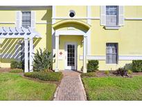 Inviting front entrance with a brick pathway, well-maintained landscaping, and a charming covered entryway at 113 Seahorse Se Dr # D, St Petersburg, FL 33705