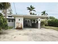 Charming single-story home features a spacious carport and well-maintained landscaping at 1519 Delaware Ne Ave, St Petersburg, FL 33703