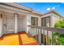 Inviting condo entrance with bright courtyard, offering both style and a secure welcome with terra cotta tile at 6357 Bahia Del Mar Blvd # 206, St Petersburg, FL 33715