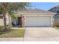 Charming single-Gathering home featuring a two-car garage and well-maintained front yard at 7233 Lumber Port Dr, Ruskin, FL 33573