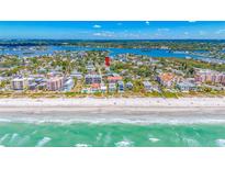 Breathtaking aerial view of a beachfront community with pristine sandy shores and turquoise waters on a sunny day at 119 13Th Ave, Indian Rocks Beach, FL 33785
