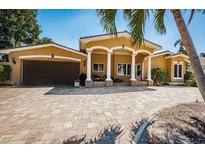 Inviting single-Gathering home featuring a charming facade, meticulously maintained lawn, and a spacious driveway at 1233 Eden Isle Ne Dr, St Petersburg, FL 33704