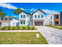 Beautiful two-story home with a well-manicured front lawn and a spacious driveway at 1741 Nevada Ne Ave, St Petersburg, FL 33703