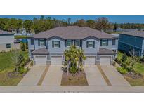 Inviting townhome exterior with a two-car garage, neutral paint, and well-maintained landscaping at 21385 Darter Rd, Land O Lakes, FL 34638