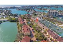 Aerial view showcasing the community with waterfront access, pool, and tennis courts at 442 Sandy Hook Rd, Treasure Island, FL 33706