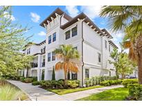 Beautiful three-story condo with manicured landscaping, showcasing its architectural details and curb appeal at 5120 Bridge St # 6, Tampa, FL 33611