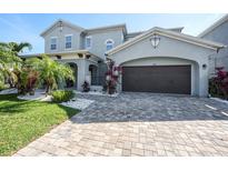 Charming two-story home with a two-car garage and a well-manicured front yard at 6617 Park Strand Dr, Apollo Beach, FL 33572