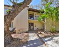 Two-story condo featuring a private balcony, a well-maintained walkway, and lush tropical landscaping at 700 Starkey Rd # 514, Largo, FL 33771