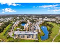 An aerial view of a beautiful condo community surrounded by lush greenery, lakes, and a golf course at 960 Starkey Rd # 5303, Largo, FL 33771