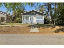 Charming blue bungalow with a well-maintained front yard and a classic, inviting appeal at 1004 E 22Nd Ave, Tampa, FL 33605
