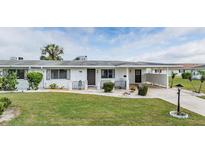 Charming single story home with well-maintained landscaping and a covered carport at 1515 Danbury Dr, Sun City Center, FL 33573