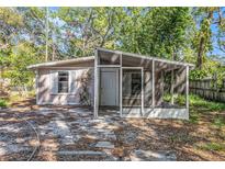 Charming single-story home with a cozy, screened front porch and natural landscaping at 15165 Waverly St, Clearwater, FL 33760