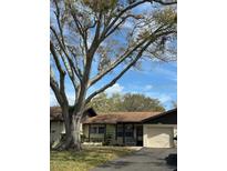 Charming single-story home featuring an attached garage and well-kept lawn at 1567 Patton Dr, Dunedin, FL 34698
