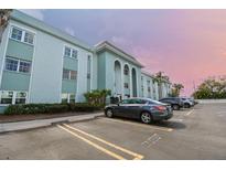 A three-story building with covered parking featuring blue paint and white trim at 1706 Belleair Forest Dr # 314, Belleair, FL 33756