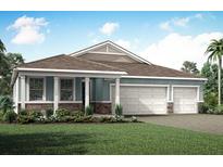 Charming single-story home showcasing stone accents and a two-car garage, nestled on a well-manicured lawn at 18604 Arbor Vista Dr, Venice, FL 34293