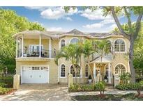 Elegant two-story home features a balcony, arched windows, and a well-maintained front yard at 2308 W Jetton Ave, Tampa, FL 33629