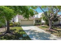Charming single-Gathering home with a two-car garage and well-manicured lawn at 370 S Woodlands Dr, Oldsmar, FL 34677