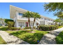 Beautiful two-story building with manicured landscaping and private balconies at 8220 112Th N St # 206, Seminole, FL 33772