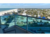 Stunning beach and ocean view from the condo's balcony with blue glass railings at 880 Mandalay Ave # N802, Clearwater Beach, FL 33767